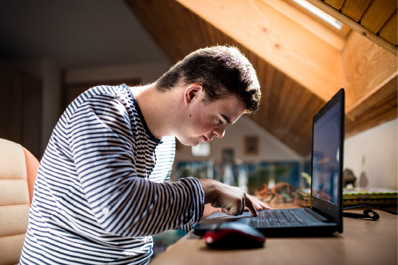 Downs Syndrome doing work on computer